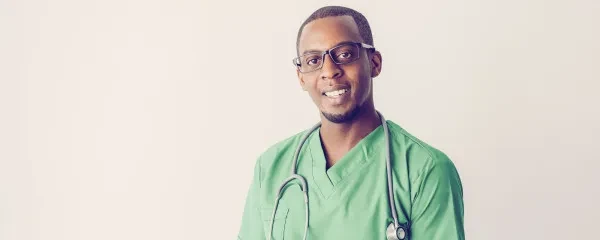 doctor smiling in green scrubs