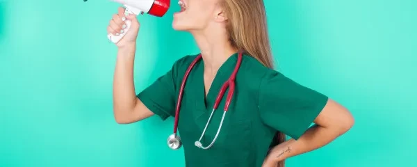 doctor in scrubs with a megaphone