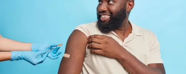 Man receiving vaccine in arm