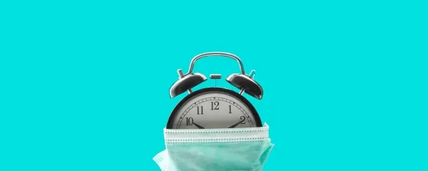 alarm clock wearing a face mask
