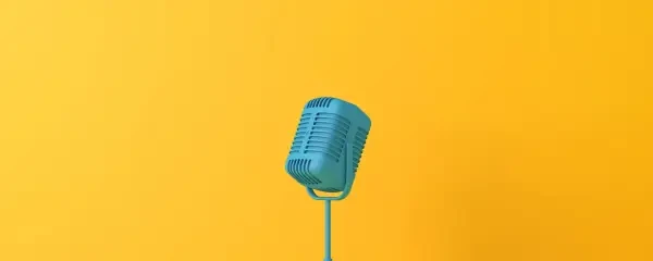Blue retro microphone on yellow background