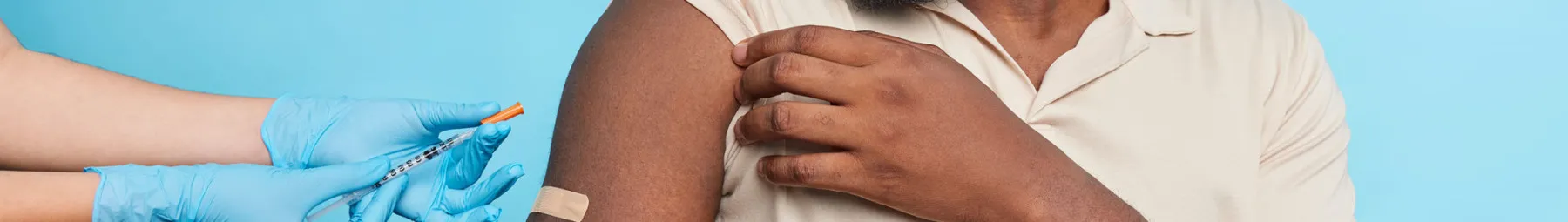 man receiving vaccines in the arm resized
