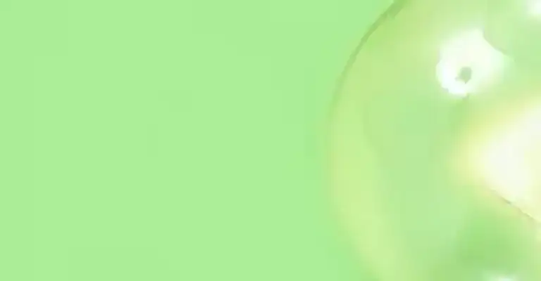 single screw fit glowing lightbulb on a green background (1)