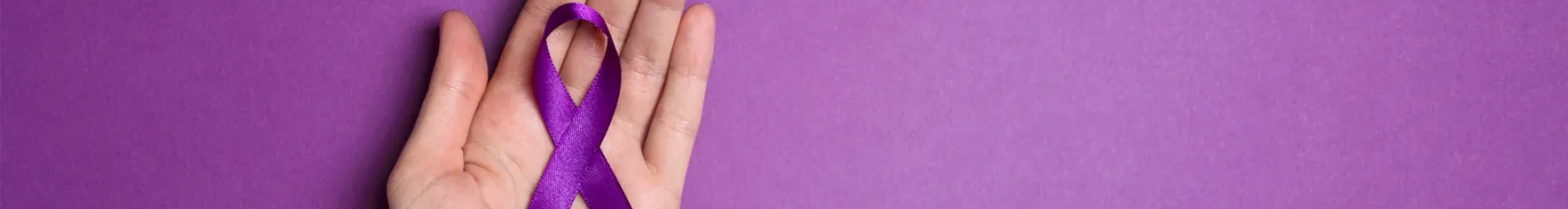Hand holding purple ribbon on a purple background (resized)