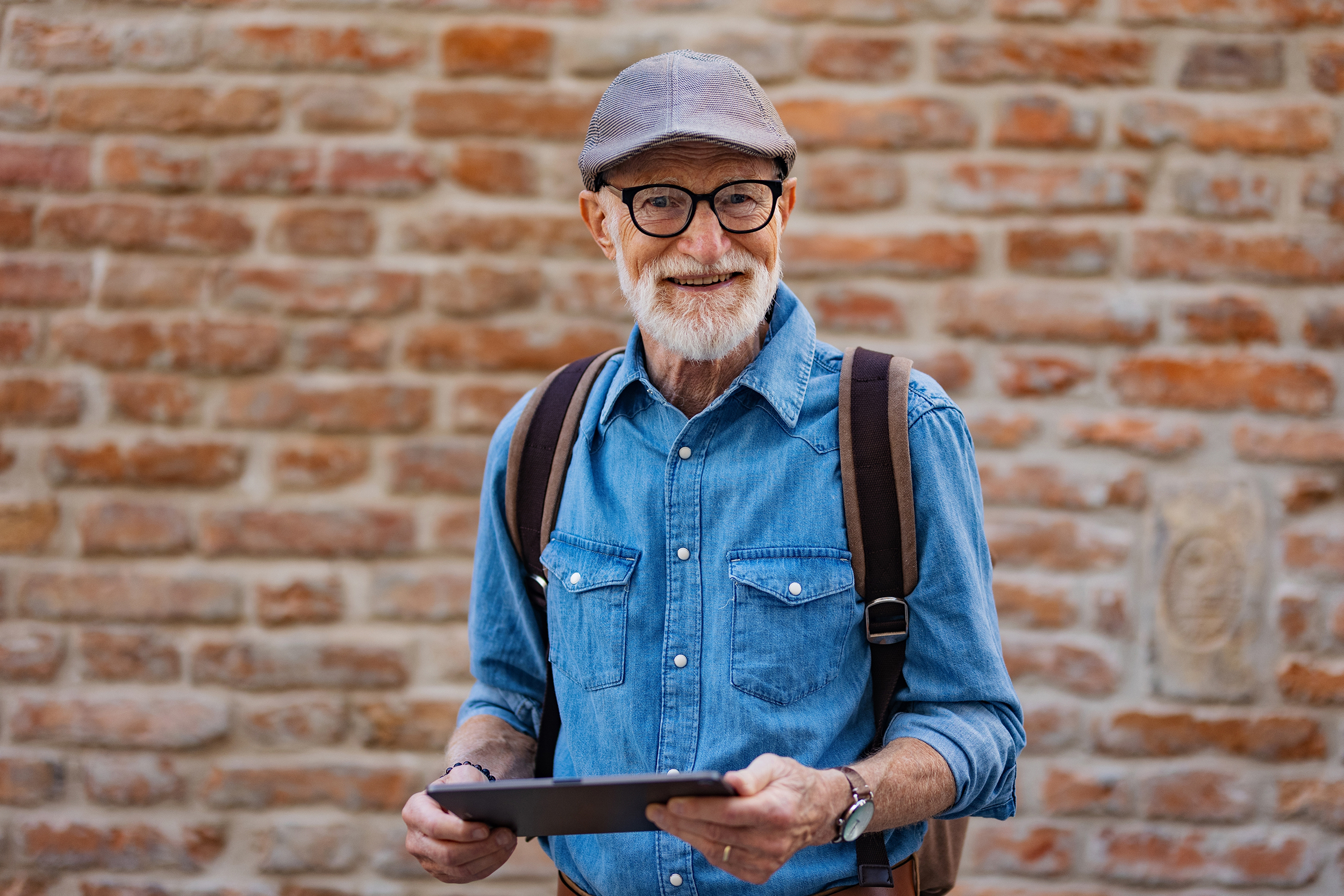Cool Older Man With Tablet Outdoors Website