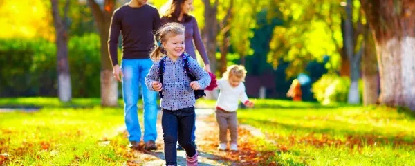 Young family walking through a park