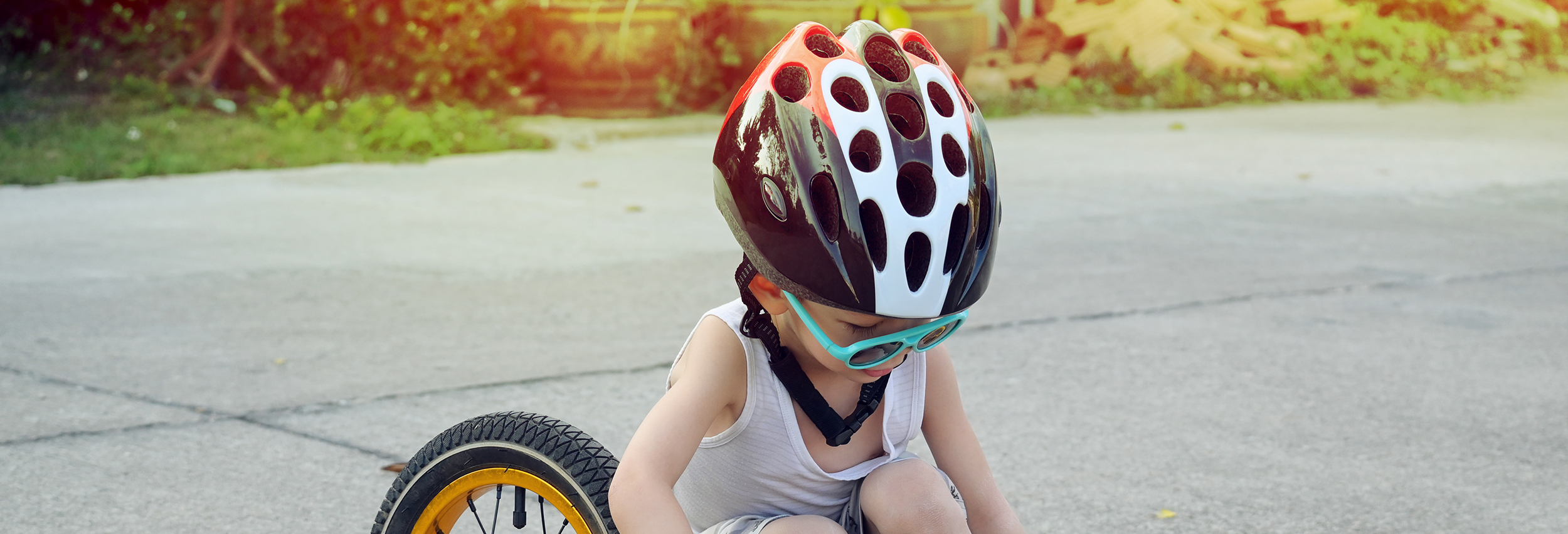 Boy Checking Bike With Helmet On Website Banner