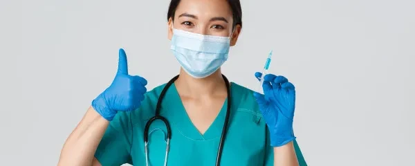 covid vaccine doctor in scrubs