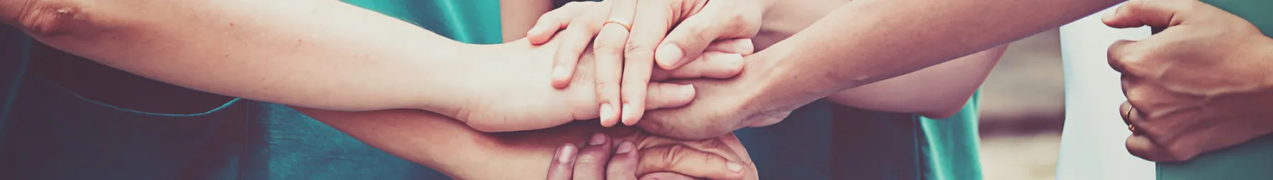 Doctors with hands on top of each other