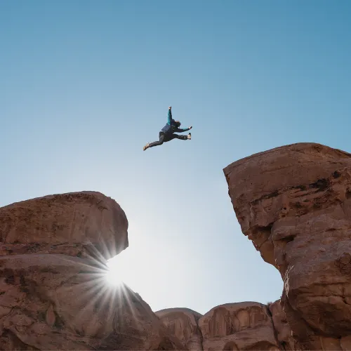 Man jumping between rocks