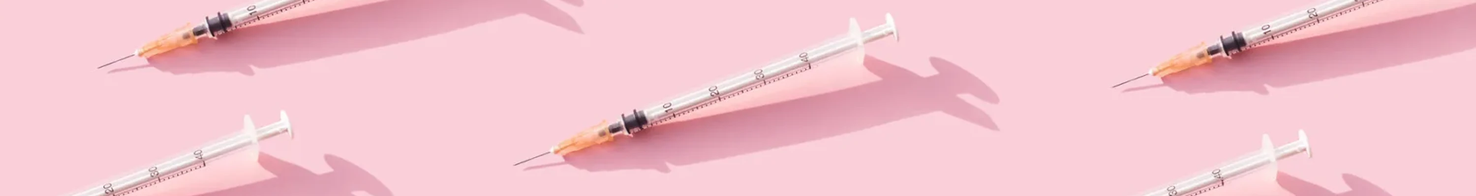 Multiple immunisation needles on a pink background (1)