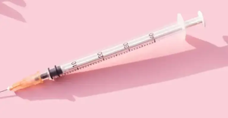 Multiple immunisation needles on a pink background (1)