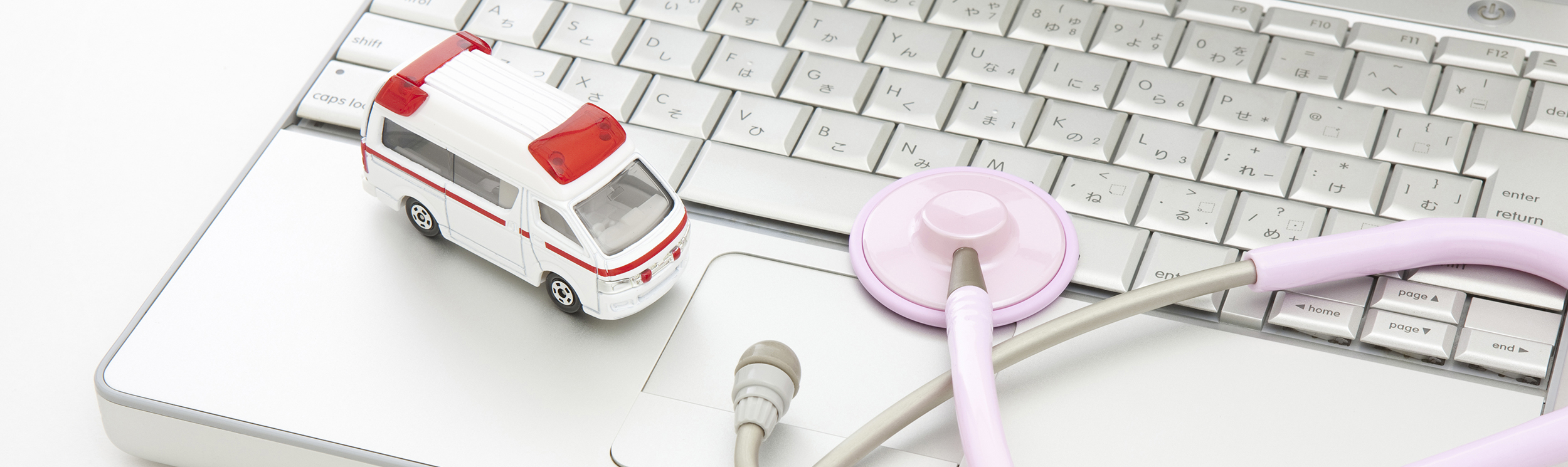 Ambulance And Stethascope On Keyboard Website Banner