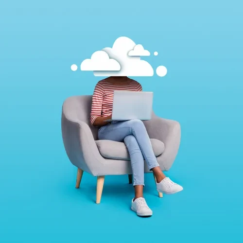 Woman sat on chair using a laptop and her head is covered by clouds