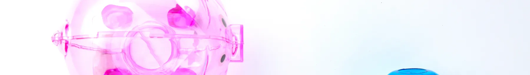 Transparent pink piggy bank and blue lightbulb