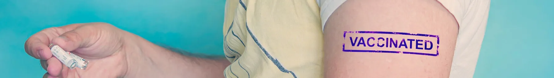 man with vaccinated stamp on arm (1)