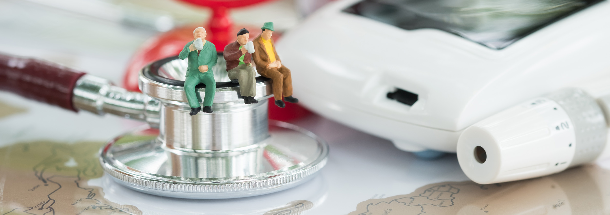 Miniature People Drinking Tea On Stethoscope Banner