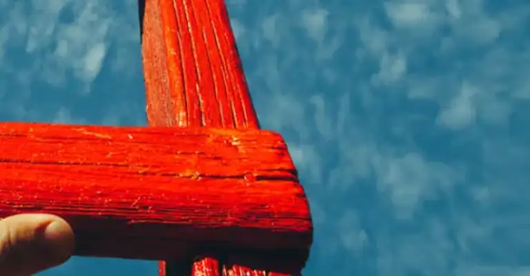 Red ladder with blue sky person's hand on ladder as climbing