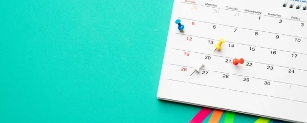 Calendar month with pins on it to mark key dates