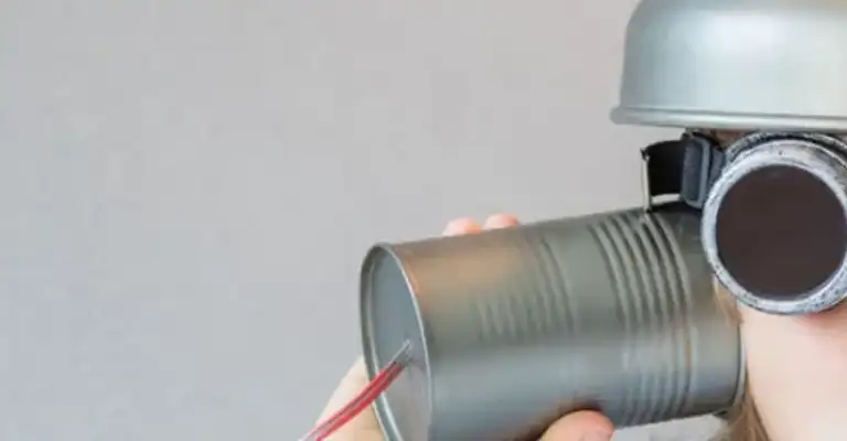 close up of child with tin can and string